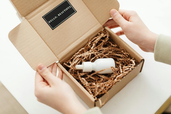 How Small Shops Create Premium Appeal with a Custom Embosser Beautiful unboxing presentation with ribbon and gift box